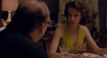Movie still from “Wildlife” (2018), directed by Paul Dano – A man and a woman sitting at a table with wine glasses; Medium shot, Over the shoulder angle