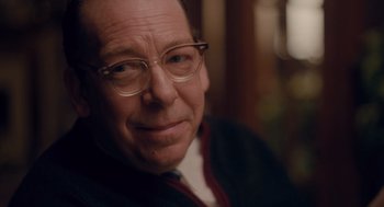 Movie still from “Wildlife” (2018), directed by Paul Dano – An older man wearing glasses and wearing a sweater; Close Up shot, Over the shoulder angle