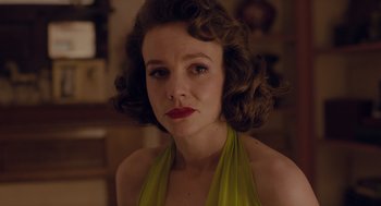 Movie still from “Wildlife” (2018), directed by Paul Dano – A person wearing a yellow dress; Close Up shot, Over the shoulder angle