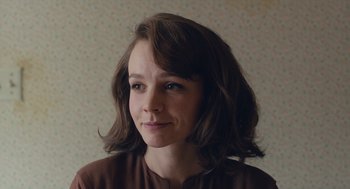 Movie still from “Wildlife” (2018), directed by Paul Dano – A person wearing a brown shirt; Close Up shot, Over the shoulder angle