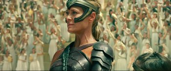 Movie still from “Wonder Woman 1984” (2020), directed by Patty Jenkins – A woman in armor is standing in front of a crowd of people; Close Up shot, Low angle