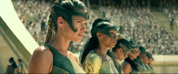 Movie still from “Wonder Woman 1984” (2020), directed by Patty Jenkins – A group of women in costume in a stadium; Close Up shot, Low angle