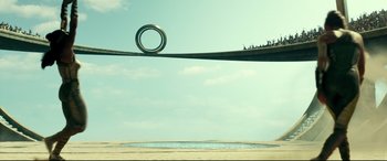 Movie still from “Wonder Woman 1984” (2020), directed by Patty Jenkins – A view of a bridge with people standing on it; Extreme Wide shot, Low angle