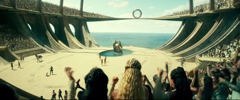 Movie still from “Wonder Woman 1984” (2020), directed by Patty Jenkins – A group of people standing on top of a sandy beach; Extreme Wide shot, High angle