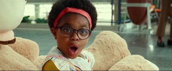 Movie still from “Wonder Woman 1984” (2020), directed by Patty Jenkins – A little girl wearing glasses and a headband; Close Up shot, Over the shoulder angle