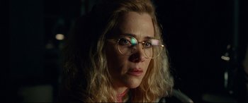 Movie still from “Wonder Woman 1984” (2020), directed by Patty Jenkins – A person wearing glasses and looking at the camera; Close Up shot, Over the shoulder angle