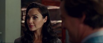 Movie still from “Wonder Woman 1984” (2020), directed by Patty Jenkins – A person sitting in a room; Close Up shot, Over the shoulder angle