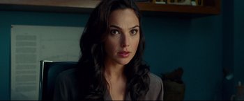 Movie still from “Wonder Woman 1984” (2020), directed by Patty Jenkins – A beautiful woman with long black hair looking at the camera; Close Up shot, Over the shoulder angle