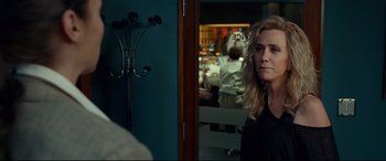 Movie still from “Wonder Woman 1984” (2020), directed by Patty Jenkins – A woman standing in front of a mirror in a room; Close Up shot, Over the shoulder angle