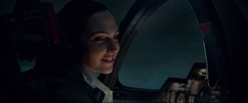 Movie still from “Wonder Woman 1984” (2020), directed by Patty Jenkins – A woman sitting in a car looking at the camera; Close Up shot, Over the shoulder angle