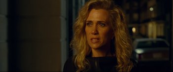 Movie still from “Wonder Woman 1984” (2020), directed by Patty Jenkins – A woman with long blonde hair looking at the camera; Close Up shot, Over the shoulder angle