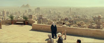 Movie still from “Wonder Woman 1984” (2020), directed by Patty Jenkins – A group of people standing on a ledge overlooking a city; Extreme Wide shot, High angle