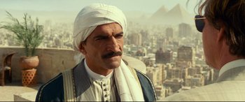 Movie still from “Wonder Woman 1984” (2020), directed by Patty Jenkins – A man with a white turban and a mustache; Close Up shot, High angle
