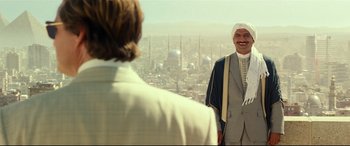 Movie still from “Wonder Woman 1984” (2020), directed by Patty Jenkins – A man standing next to another man on a hill; Medium shot, Over the shoulder angle