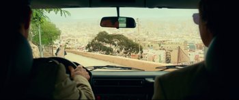 Movie still from “Wonder Woman 1984” (2020), directed by Patty Jenkins – A view from inside a car looking out over a city; Wide shot, Over the shoulder angle