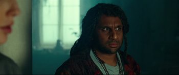 Movie still from “Wonder Woman 1984” (2020), directed by Patty Jenkins – A person with long dreadlocks; Close Up shot, Over the shoulder angle