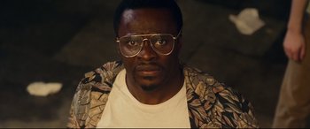 Movie still from “Wonder Woman 1984” (2020), directed by Patty Jenkins – A person wearing glasses; Close Up shot, High angle