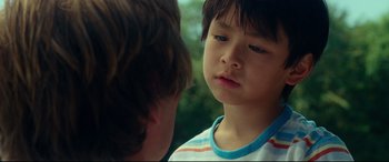 Movie still from “Wonder Woman 1984” (2020), directed by Patty Jenkins – A young boy looking at another young boy; Close Up shot, Over the shoulder angle