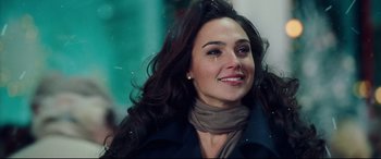 Movie still from “Wonder Woman 1984” (2020), directed by Patty Jenkins – A beautiful woman with long hair wearing a scarf; Close Up shot, Over the shoulder angle