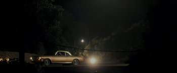 Movie still from “Zodiac” (2007), directed by David Fincher – A car is parked on the side of the road at night; Extreme Wide shot, Low angle