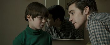 Movie still from “Zodiac” (2007), directed by David Fincher – A young boy and a young man looking at each other in a mirror; Medium shot, Over the shoulder angle