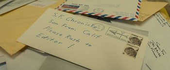 Movie still from “Zodiac” (2007), directed by David Fincher – Two envelopes that are sitting side by side on top of a table; Extreme Close Up shot, High angle