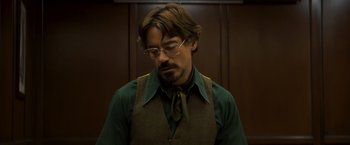 Movie still from “Zodiac” (2007), directed by David Fincher – A man in a green shirt and a brown tie; Close Up shot, Low angle