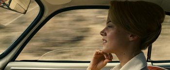 Movie still from “Zodiac” (2007), directed by David Fincher – A woman sitting in the passenger seat of a car looking out the window; Close Up shot, Low angle