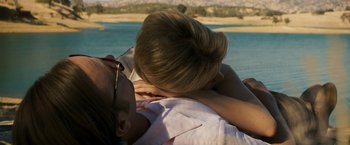 Movie still from “Zodiac” (2007), directed by David Fincher – A man and a woman laying on the ground; Close Up shot, High angle