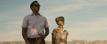 Movie still from “Zodiac” (2007), directed by David Fincher – A man and a woman standing next to each other in front of mountains; Medium shot, Low angle