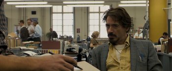 Movie still from “Zodiac” (2007), directed by David Fincher – A man sitting at a table with a pen and paper; Close Up shot, Over the shoulder angle