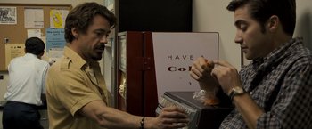 Movie still from “Zodiac” (2007), directed by David Fincher – A man and a woman at a counter with a hot dog; Medium shot, Over the shoulder angle