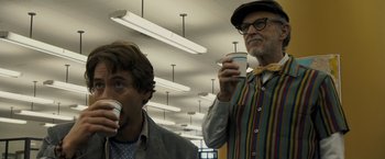 Movie still from “Zodiac” (2007), directed by David Fincher – Two men are drinking coffee in a room; Close Up shot, Low angle