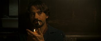Movie still from “Zodiac” (2007), directed by David Fincher – A man holding a lit cigarette in his mouth; Close Up shot, Over the shoulder angle