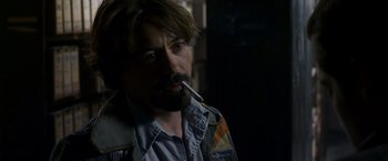 Movie still from “Zodiac” (2007), directed by David Fincher – A person smoking a cigarette; Close Up shot, Over the shoulder angle