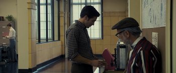 Movie still from “Zodiac” (2007), directed by David Fincher – A man standing in front of a coffee maker; Medium shot, Over the shoulder angle
