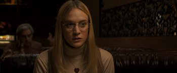 Movie still from “Zodiac” (2007), directed by David Fincher – A woman with glasses and long blonde hair wearing glasses; Close Up shot, Over the shoulder angle