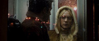 Movie still from “Zodiac” (2007), directed by David Fincher – A man and a woman looking out of a window; Close Up shot, Over the shoulder angle