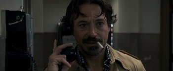 Movie still from “Zodiac” (2007), directed by David Fincher – A person talking on a phone; Close Up shot, Over the shoulder angle