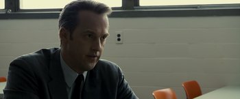 Movie still from “Zodiac” (2007), directed by David Fincher – A person wearing a suit and tie; Close Up shot, Over the shoulder angle