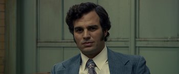 Movie still from “Zodiac” (2007), directed by David Fincher – A person wearing a suit and tie; Close Up shot, Low angle