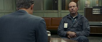 Movie still from “Zodiac” (2007), directed by David Fincher – Two men sitting at a table in front of each other; Medium shot, Over the shoulder angle