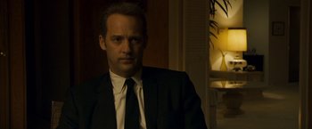 Movie still from “Zodiac” (2007), directed by David Fincher – A person wearing a suit and tie; Close Up shot, Over the shoulder angle