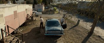 Movie still from “Zodiac” (2007), directed by David Fincher – Two men are loading luggage into a car; Extreme Wide shot, High angle