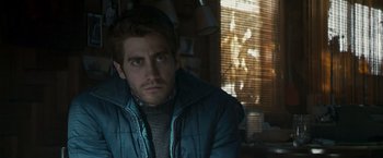 Movie still from “Zodiac” (2007), directed by David Fincher – A person wearing a jacket; Close Up shot, Over the shoulder angle