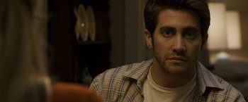 Movie still from “Zodiac” (2007), directed by David Fincher – A person sitting in a room; Close Up shot, Over the shoulder angle