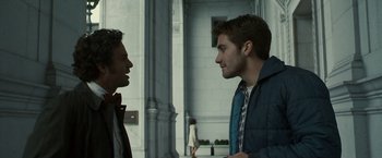 Movie still from “Zodiac” (2007), directed by David Fincher – Two men talking to each other in front of a building; Medium shot, Over the shoulder angle
