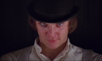 Movie still from “A Clockwork Orange” (1971), directed by Stanley Kubrick – A person wearing a top hat; Close Up shot, Low angle