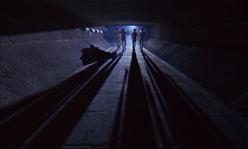 Movie still from “A Clockwork Orange” (1971), directed by Stanley Kubrick – A group of skateboarders standing in a tunnel; Extreme Wide shot, High angle