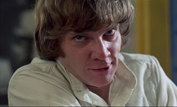 Movie still from “A Clockwork Orange” (1971), directed by Stanley Kubrick – A person wearing a white shirt; Close Up shot, Low angle